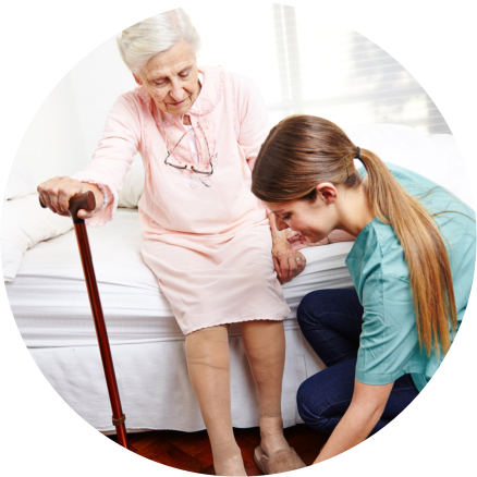 Caregiver helping an Elderly in wearing slippers